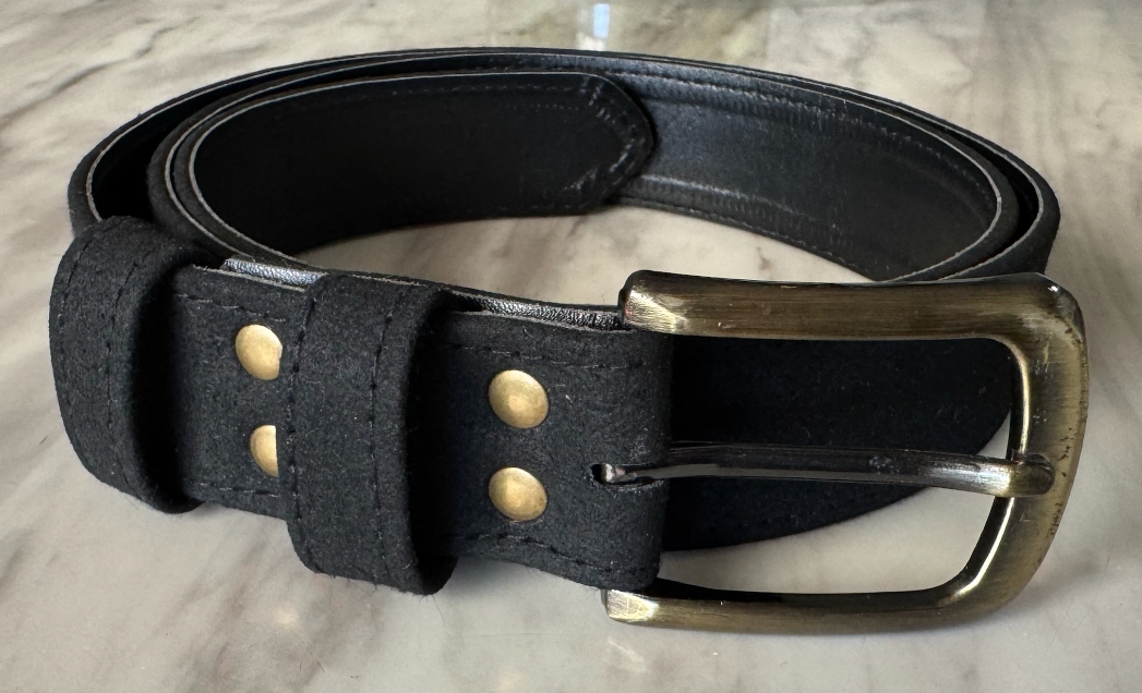 Black VEGAN SUEDE belt with brass buckle on a light gray surface