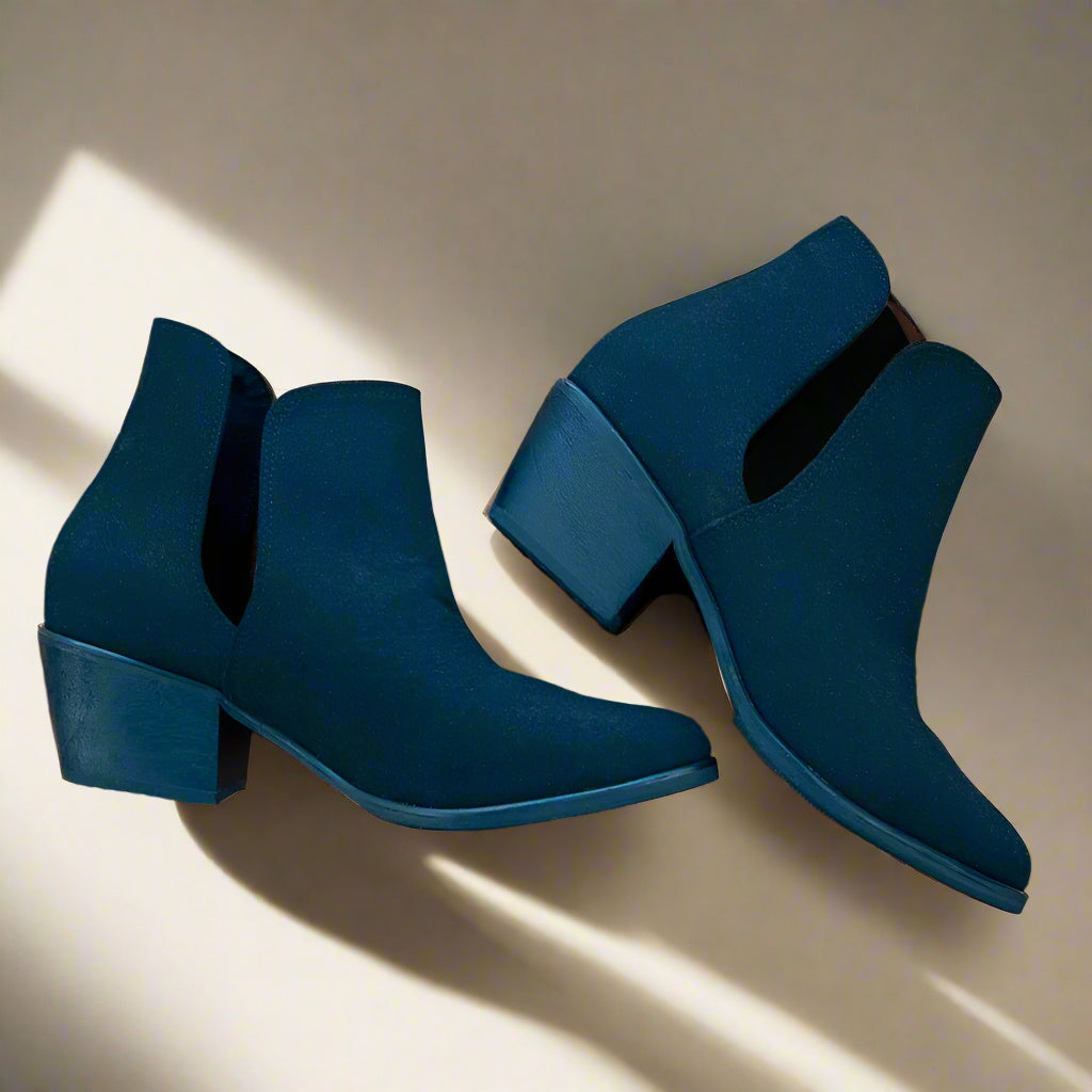 A pair of black vegan suede boots with a low heel and pointed toe