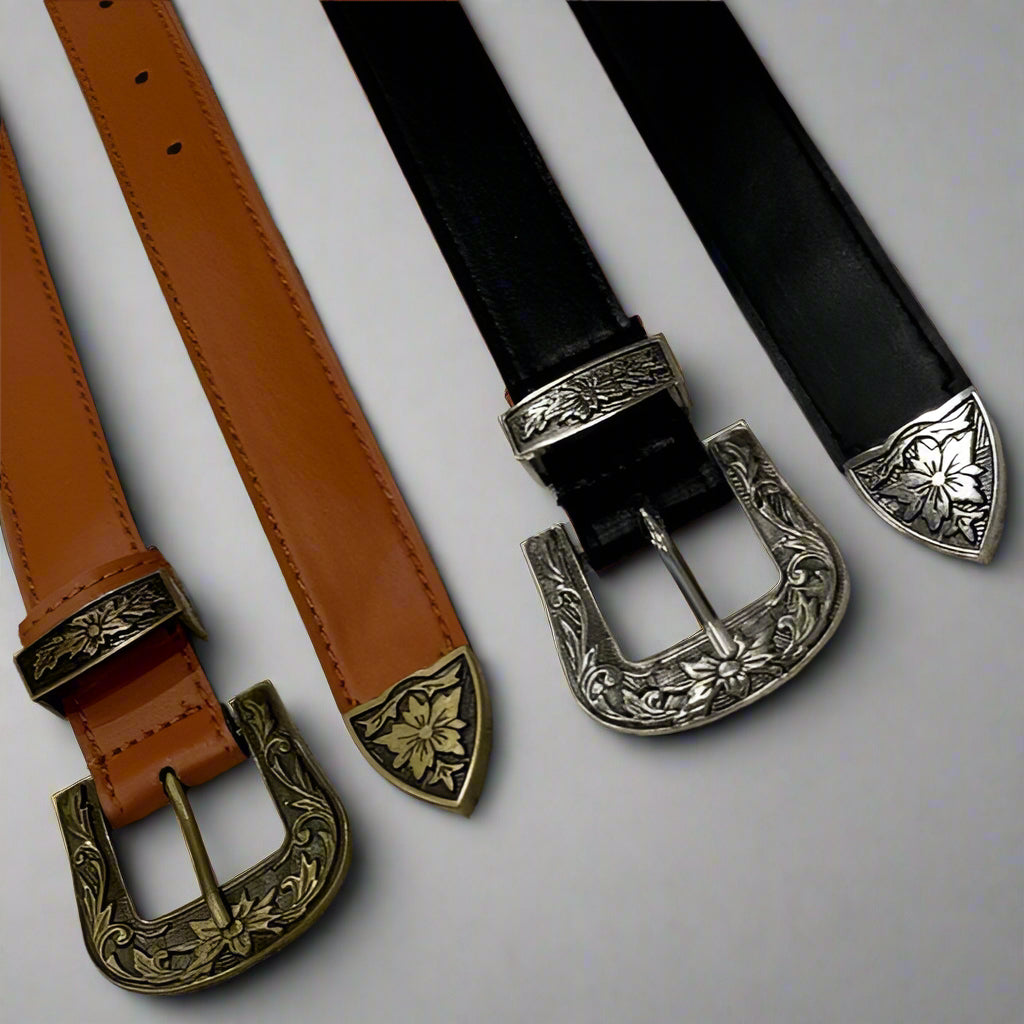 Three western-style belts with buckles, displayed in black, brown, and tan colors, showing the texture and design of the leather and metal buckles.