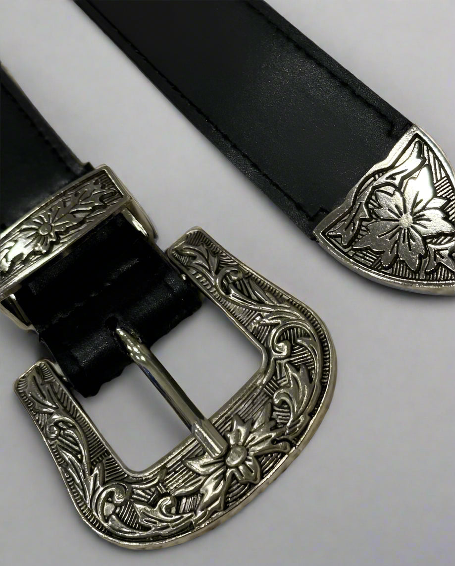 A vegan leather western belt with a black strap and a silver-colored ornate buckle
