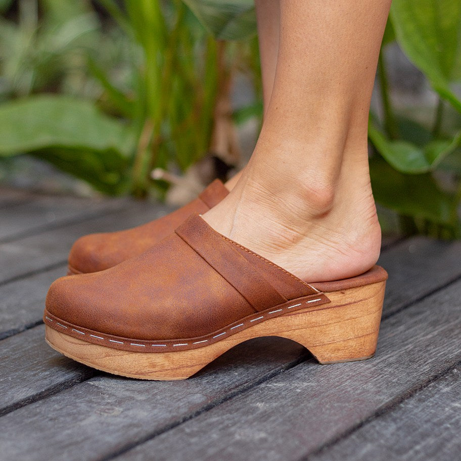 Flat handmade vegan clogs in vegan leather suede for women. Crafted from a single piece of lightweight Bali wood. 5cm and with a padded leather wrapped base for comfort. Vegan Shoes Sydney. Cruelty-free. Small business. Fair work and pay. Vegan sandals mules summer slip on shoes vegan women sandles holiday vintage boho