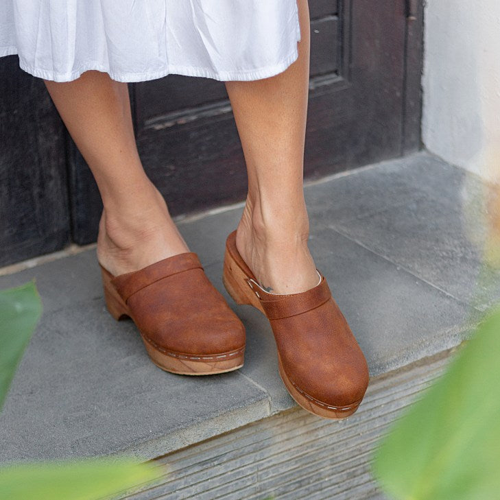 Flat handmade vegan clogs in vegan leather suede for women. Crafted from a single piece of lightweight Bali wood. 5cm and with a padded leather wrapped base for comfort. Vegan Shoes Sydney. Cruelty-free. Small business. Fair work and pay. Vegan sandals mules summer slip on shoes vegan women sandles holiday vintage boho