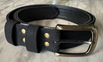 Black VEGAN SUEDE belt with brass buckle on a light gray surface