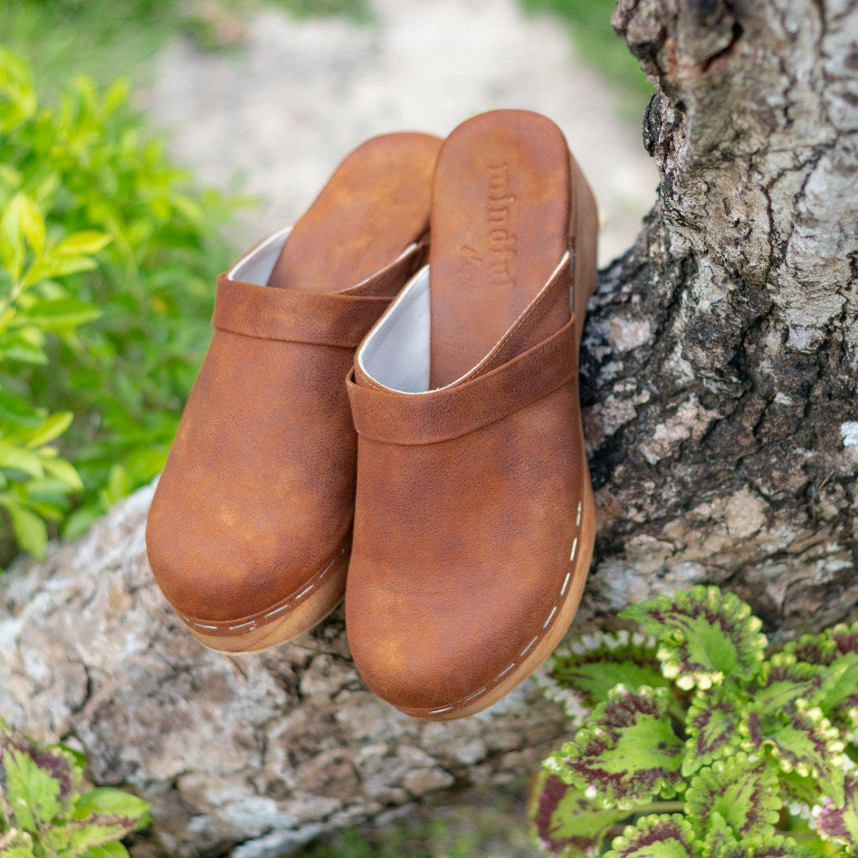 Flat handmade vegan clogs in vegan leather suede for women. Crafted from a single piece of lightweight Bali wood. 5cm and with a padded leather wrapped base for comfort. Vegan Shoes Sydney. Cruelty-free. Small business. Fair work and pay. Vegan sandals mules summer slip on shoes vegan women sandles holiday vintage boho